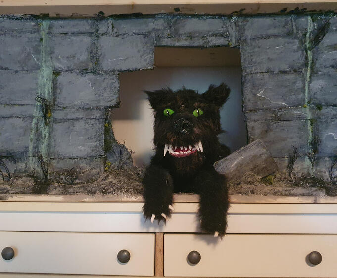 Gmork in his bookcase/cave